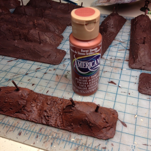 Next is a fairly heavy coat of cheapo burnt sienna., because there's a lot of red in dirt! I put this on in  a dry-brushy kind of way, but I don't take anywhere near as much paint of the brush as you should when doing traditional drybrushing.
