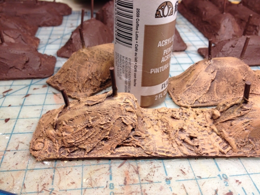 Now I use this deliciously named color (coffee-latte), and apply another heavy drybrush over the previous coats. You could probably end your investment in the dirt painting business here, if you're pressed for time. Coffee-latte is a dark tan, just this side of medium brown. That should help.